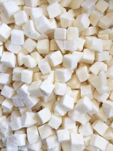 A close up of cubes of white sugar