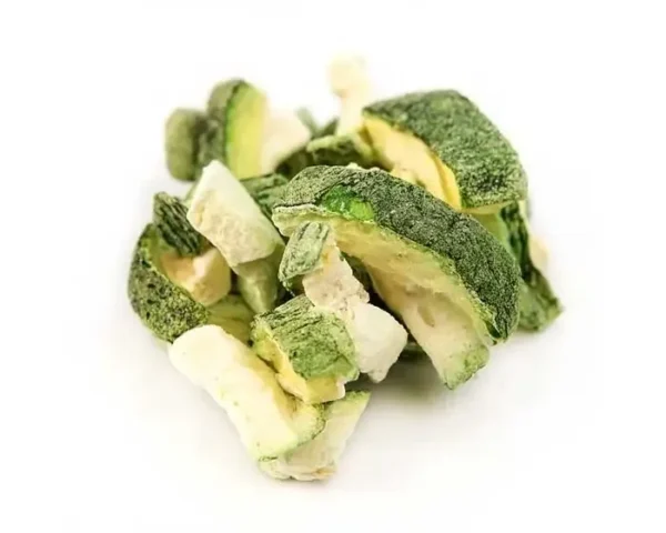 A pile of broccoli and other vegetables on top of a white surface.