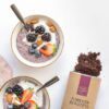 Two bowls of food with berries and chocolate chips.